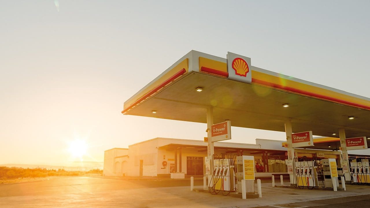 The forecourt of a shell service station at dusk