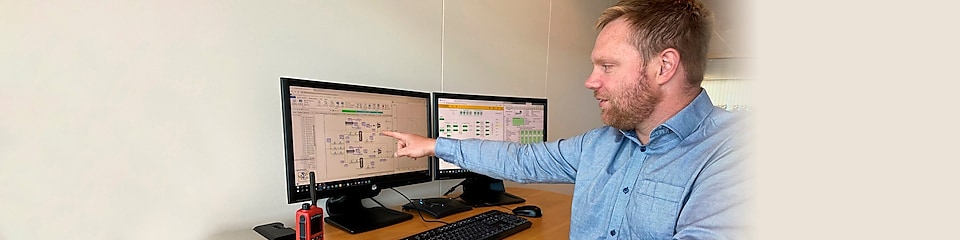 Magnus is pointing at a process map on a computer.