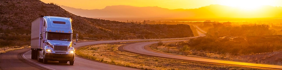18-wheeler on interstate highway at sunset