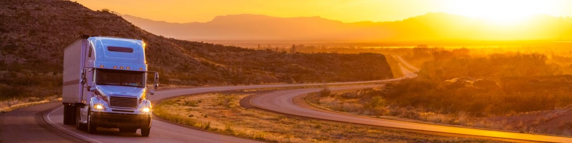 18 wheeler on interstate highway at sunset