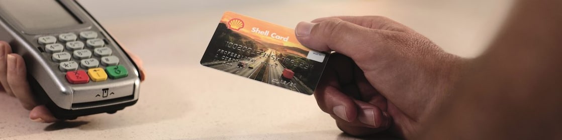 a hand, holding euroShell card