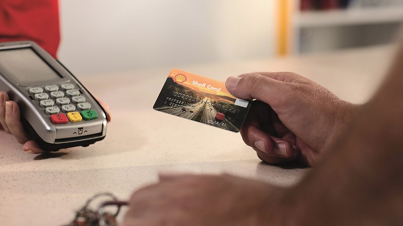 a hand, holding euroShell card