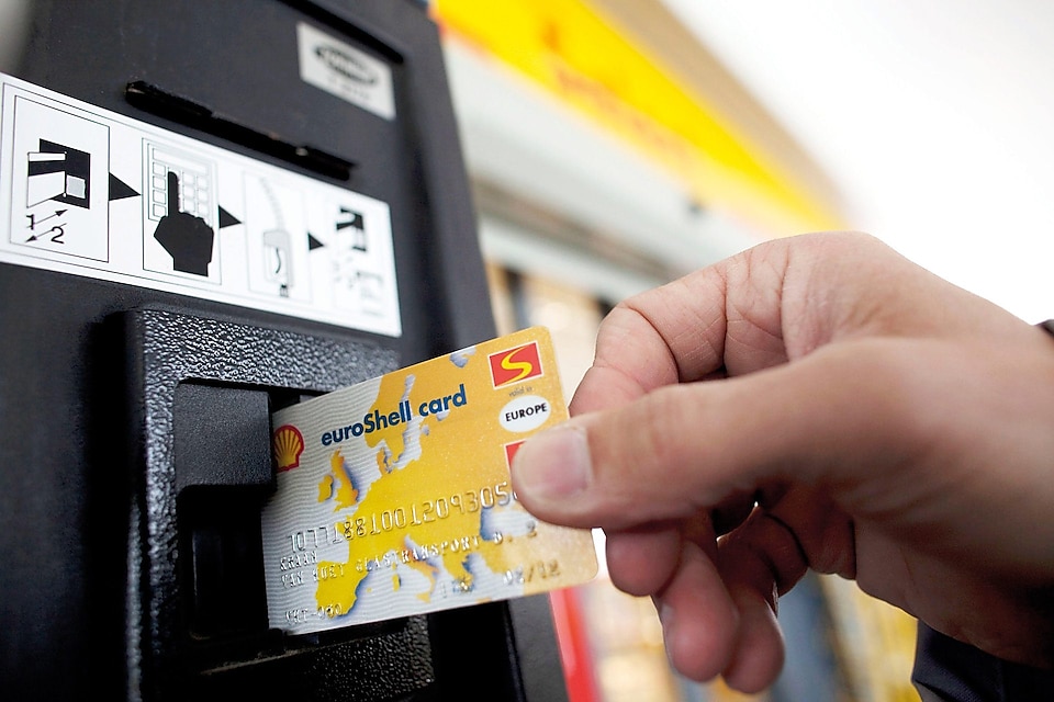 person swiping shell card in reader machine