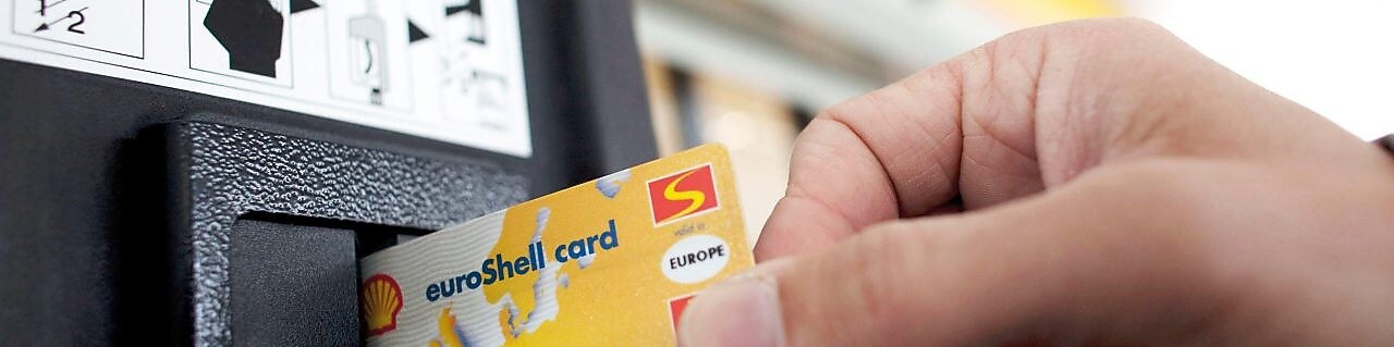 person swiping shell card in reader machine