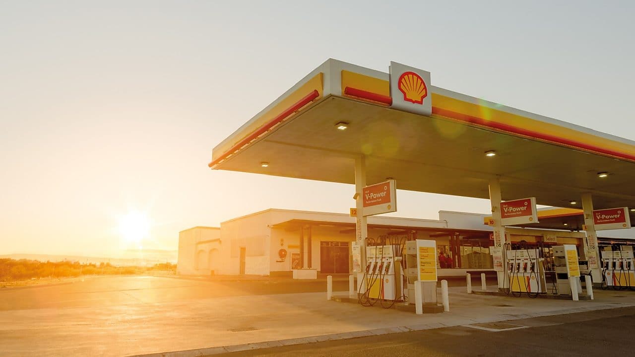 The forecourt of a shell service station at dusk
