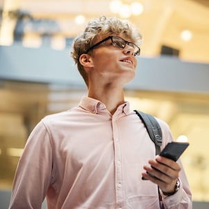 Businessman in modern office holding a mobile phone