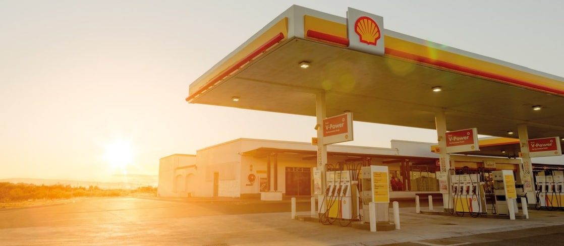 The forecourt of a shell service station at dusk